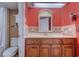 Bathroom features a vanity with wood cabinets and a red wall at 1501 S Ocean Blvd. # 1038, Myrtle Beach, SC 29577