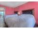 Bedroom with two beds, ocean view, and pink walls at 1501 S Ocean Blvd. # 1038, Myrtle Beach, SC 29577