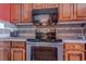 Close up of kitchen with wood cabinets and stove at 1501 S Ocean Blvd. # 1038, Myrtle Beach, SC 29577