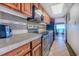 Small kitchen with wood cabinets and modern appliances at 1501 S Ocean Blvd. # 1038, Myrtle Beach, SC 29577