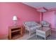 Living room with wicker furniture and pink walls at 1501 S Ocean Blvd. # 1038, Myrtle Beach, SC 29577