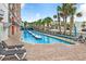 Expansive outdoor pool with lounge chairs and nearby palm trees at 1501 S Ocean Blvd. # 1038, Myrtle Beach, SC 29577