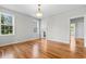 Sunlit dining room with hardwood floors, open to living room at 432 N Smith Rd., Mullins, SC 29574
