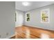Spacious bedroom with hardwood floors and large windows providing natural light at 432 N Smith Rd., Mullins, SC 29574