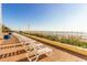 Brick patio with white lounge chairs overlooking the beach at 1207 S Ocean Blvd. # 20703, Myrtle Beach, SC 29577