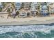 Beachfront homes and sandy beach; showcasing ocean views and neighborhood at 551 S Waccamaw Dr., Garden City Beach, SC 29576