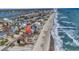 Aerial view of beach house community, showcasing oceanfront location at 551 S Waccamaw Dr., Garden City Beach, SC 29576