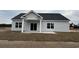 Rear exterior view of house with sliding glass doors leading to a patio at 3854 Red Bluff Rd., Loris, SC 29569