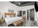 King-size bed, leather chairs, and a stylish decor in this bedroom at 324 54Th Ave. N, North Myrtle Beach, SC 29582