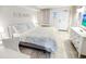 King-size bed and white chair in a condo bedroom at 2301 N Ocean Blvd. # 531, Myrtle Beach, SC 29577