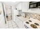 Clean white kitchen with a microwave and stove at 2301 N Ocean Blvd. # 531, Myrtle Beach, SC 29577