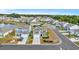 Aerial view of a charming neighborhood with houses and a pond at 2000 Musgrove Mill Way, Myrtle Beach, SC 29579