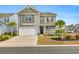 Two-story home with attached garage and charming front porch at 2000 Musgrove Mill Way, Myrtle Beach, SC 29579