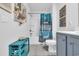 Bathroom with a tub, shower, gray vanity, and blue accents at 2000 Musgrove Mill Way, Myrtle Beach, SC 29579