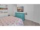Bedroom with flamingo bedding, teal dresser, and wall-mounted TV at 2000 Musgrove Mill Way, Myrtle Beach, SC 29579