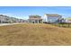 Large backyard with home and neighborhood view at 2000 Musgrove Mill Way, Myrtle Beach, SC 29579