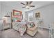 Bedroom with coastal decor, queen bed, and ceiling fan at 2000 Musgrove Mill Way, Myrtle Beach, SC 29579