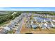 Aerial view of neighborhood with houses, pond, and roads at 2000 Musgrove Mill Way, Myrtle Beach, SC 29579