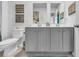 Bathroom with double vanity, gray cabinets, and decorative wall art at 2000 Musgrove Mill Way, Myrtle Beach, SC 29579