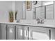 Double vanity bathroom with gray cabinets and a walk-in shower at 2000 Musgrove Mill Way, Myrtle Beach, SC 29579