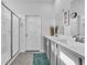 Bathroom featuring double sinks, gray cabinets, and a shower at 2000 Musgrove Mill Way, Myrtle Beach, SC 29579