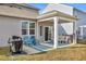Covered patio with seating area, grill, and grassy yard at 2000 Musgrove Mill Way, Myrtle Beach, SC 29579