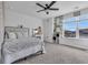 Bedroom with plush bedding, ceiling fan, and a view at 2000 Musgrove Mill Way, Myrtle Beach, SC 29579