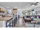 Open concept kitchen with island, seating, and living area view at 2000 Musgrove Mill Way, Myrtle Beach, SC 29579