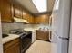 Kitchen with wood cabinets, appliances, and tile floor at 5001 Little River Rd. # E115, Myrtle Beach, SC 29577
