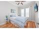 Cozy bedroom with hardwood floors, blue bedding, and mounted TV at 1426 Peterson St., Myrtle Beach, SC 29577