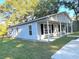 Newly built light gray house with covered porch and a grassy yard at 23 Gabe Pl., Pawleys Island, SC 29585