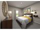 Well-lit bedroom with a queen bed, nightstand, and stylish decor at 1213 Glenrose Ct Nw, Calabash, NC 28467