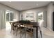 Bright dining room features a rustic wooden table with seating for six and access to the backyard at 1213 Glenrose Ct Nw, Calabash, NC 28467