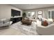 Spacious living room with comfortable seating, large TV, and a modern coffee table at 1213 Glenrose Ct Nw, Calabash, NC 28467