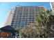 High-rise building with numerous balconies and palm trees at 4800 S Ocean Blvd. # 1522, North Myrtle Beach, SC 29582