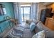 Living room with ocean view and comfortable seating at 4800 S Ocean Blvd. # 1522, North Myrtle Beach, SC 29582