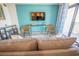 Living room with sofa and chairs facing a wall mounted TV at 4800 S Ocean Blvd. # 1522, North Myrtle Beach, SC 29582