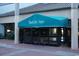 Welcoming entrance to Beach Cove Resort with teal awning at 4800 S Ocean Blvd. # 1522, North Myrtle Beach, SC 29582