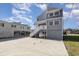 Two-story home with gray siding, elevated design, and ample parking at 206 56Th Ave. N, North Myrtle Beach, SC 29582