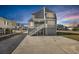 Side view of elevated beach house with stairs at 206 56Th Ave. N, North Myrtle Beach, SC 29582
