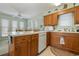 Kitchen with island, white appliances, and wooden cabinets at 206 56Th Ave. N, North Myrtle Beach, SC 29582