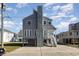 Two-story home with gray siding, elevated design, and a large stone chimney at 206 56Th Ave. N, North Myrtle Beach, SC 29582