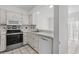 Bright eat-in kitchen features white cabinetry, stainless steel appliances, and tile flooring at 2925 Carriage Row Ln. # 134, Myrtle Beach, SC 29577