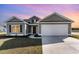 Gray house with white garage door and landscaping at 1006 Stump Rd., Conway, SC 29526