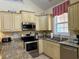 L-shaped kitchen with granite countertops and stainless steel appliances at 101 Georges Bay Rd., Surfside Beach, SC 29575
