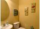 Small bathroom with a toilet, sink, and coastal-themed artwork at 101 Georges Bay Rd., Surfside Beach, SC 29575