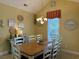 Bright dining room with a large wooden table and white chairs at 101 Georges Bay Rd., Surfside Beach, SC 29575