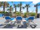 Outdoor pool deck area with lounge chairs and a view of palm trees at 2709 Ocean Blvd. S # 1202, Myrtle Beach, SC 29577