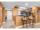 Kitchen with breakfast bar, two stools, and view into main living area at 2709 Ocean Blvd. S # 1202, Myrtle Beach, SC 29577