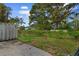 Overgrown backyard with wooden fence and concrete patio at 4505 N Kings Hwy. # C3, Myrtle Beach, SC 29577